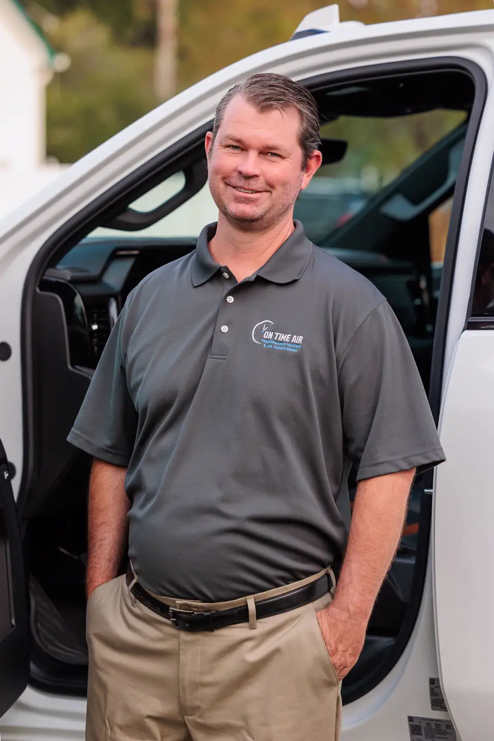 Bryan Donaldson, owner of On Time Air, beside a service truck