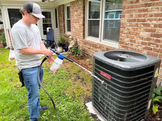 Technician performing a maintenance inspection on an indoor coil