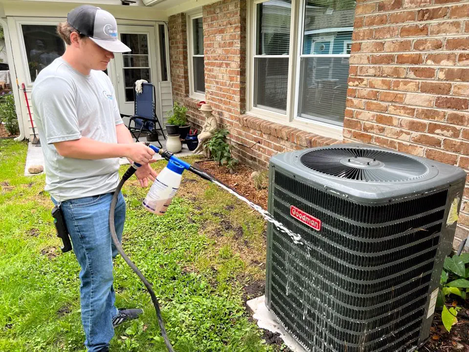 Technician performing a maintenance inspection on an indoor coil