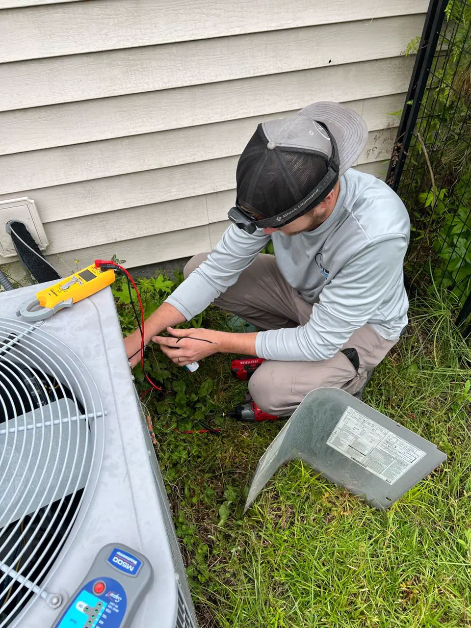 Technician inspecting a gas furnace burner assembly