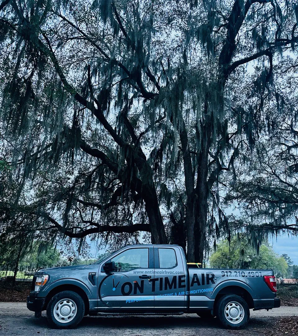 On Time Air trucks parked beneath live oaks